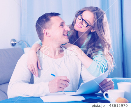 Couple signing papers Couple signing papers 48612970