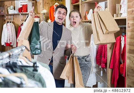 Young woman and man are standing satisfied with packadge after shopping 48612972