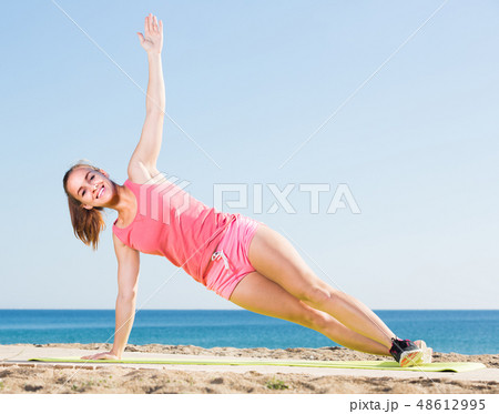 woman working out in beach 48612995