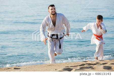 Man and boy exercising karate 48613143