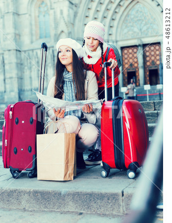 girl with mother holding map outdoors 48613212