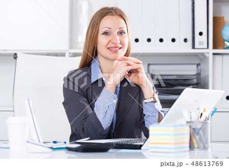 Cheerful businesswoman at workplace 48613769