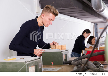 Young architect making architectural model 48613814