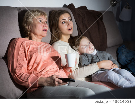 Family is watching emotional film in evening Family is watching emotional film in evening 48614053