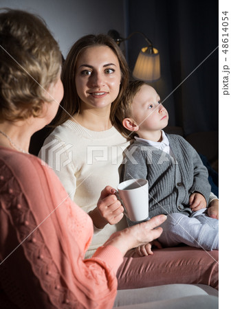 Adult female with her mother are talking about life and evening leisure Adult female with her mother are talking about life and evening leisure 48614054