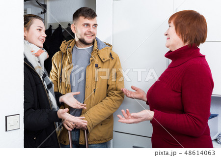 Smiling guy with wife visiting his mother 48614063