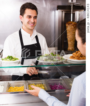 Male worker serving customer Male worker serving customer 48614143
