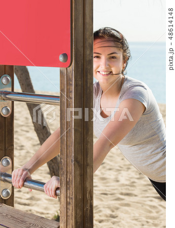 girl doing workout on beach in sunny morning girl doing workout on beach in sunny morning 48614148