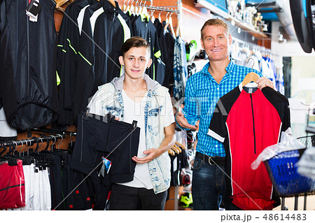 Teenager with man looking sport jackets Teenager with man looking sport jackets 48614483