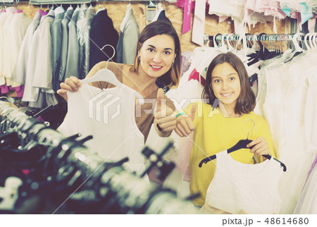 Mother and daughter showing their purchases 48614680