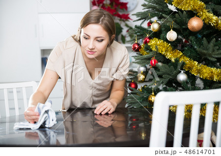 Woman wiping dust on table 48614701