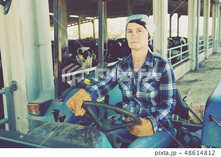 woman working on small farm tractor 48614812
