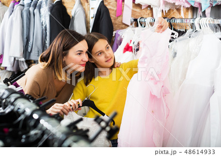 Family choosing dress in shop Family choosing dress in shop 48614933