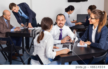 Coworkers working effectively on business project together 48614934