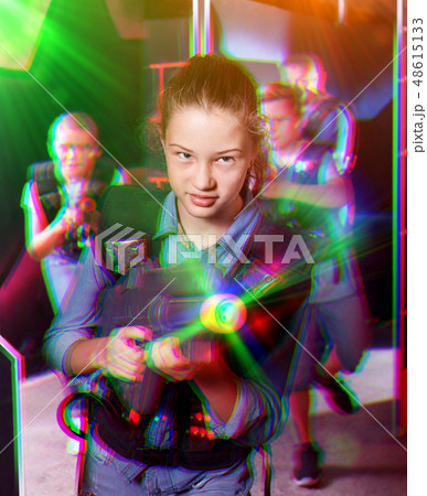 Teen girl with laser pistol on dark labyrinth 48615133