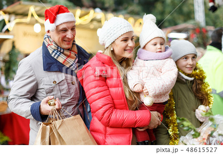 Family spending time at Christmas fair Family spending time at Christmas fair 48615527