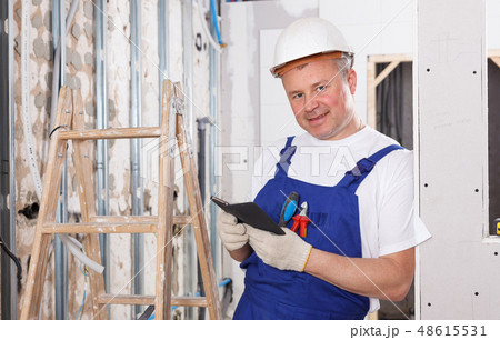 Contractor with phone in hands Contractor with phone in hands 48615531