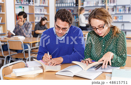 Young people preparing for exam in library 48615751