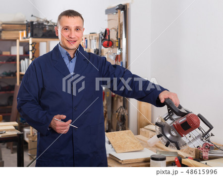carpenter with fret saw cutting wood plank at workshop carpenter with fret saw cutting wood plank at workshop 48615996