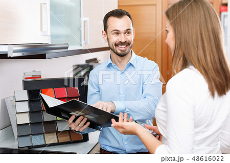 Competent seller consulting female customer in store of kitchen furnishing and appliances 48616022