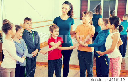 Boys and girls studying folk dance in studio 48616150