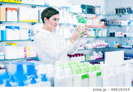 Female client is browsing rows of body care products 48616344