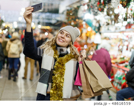 Smiling young woman taking selfie Smiling young woman taking selfie 48616559