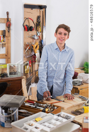 Teenager working with wood Teenager working with wood 48616579