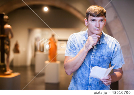Man with information booklet in museum 48616700