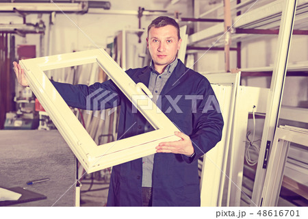 Handsome labour demonstrating PVC profiles 48616701