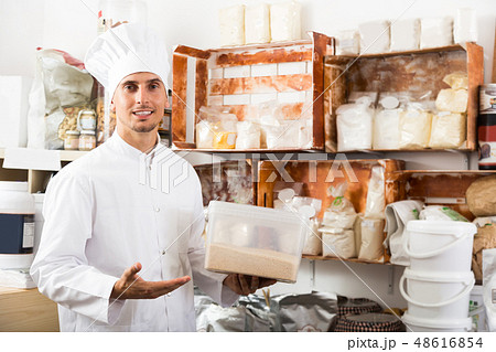 cook taking flour in pantry room. cook taking flour in pantry room. 48616854