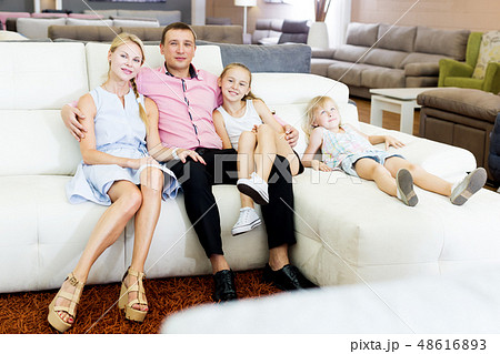 Family is satisfied by new bought sofa 48616893