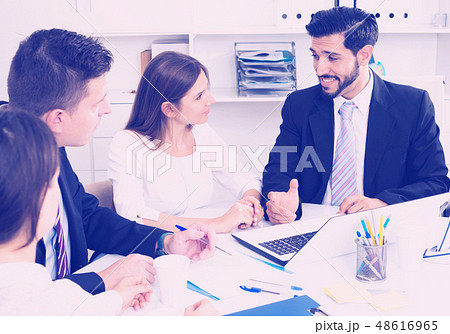 Businessman discussing with team Businessman discussing with team 48616965