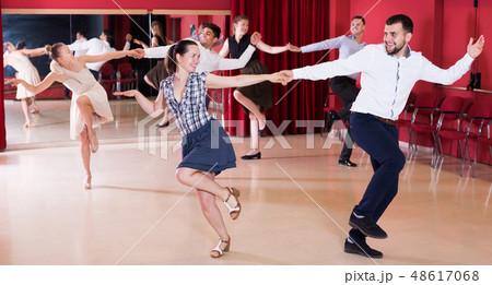 Dancing couples enjoying latin dances Dancing couples enjoying latin dances 48617068