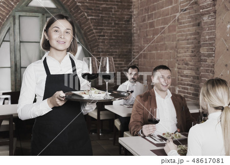 Glad female waiter showing country restaurant 48617081