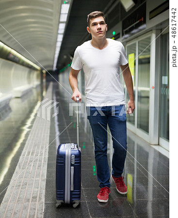 Man with luggage bag in subway station Man with luggage bag in subway station 48617442