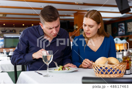 Couple demonstrating dissatisfaction in restaurant 48617463