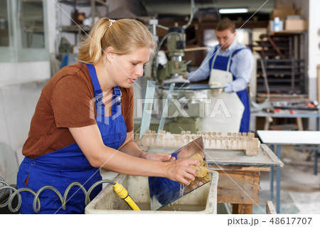 Female worker cleaning glass Female worker cleaning glass 48617707