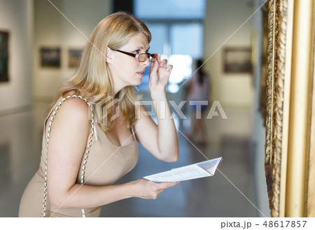 Woman trying to see picture 48617857