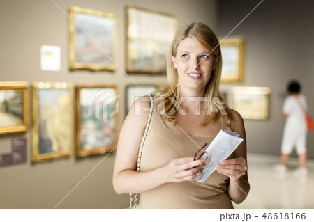 Woman with glasses visiting museum of arts 48618166