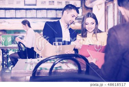 Couple is choosing order for dinner Couple is choosing order for dinner 48618517