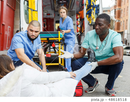 Paramedics providing first aid to woman 48618518
