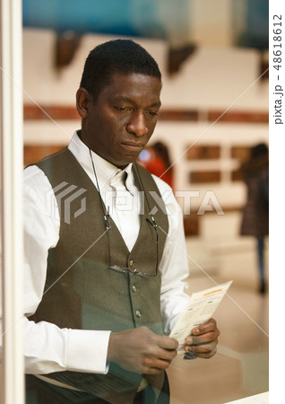 African man looking at exhibit African man looking at exhibit 48618612