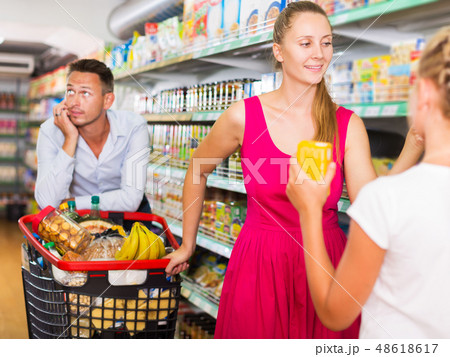 frustration man with family in supermarket 48618617