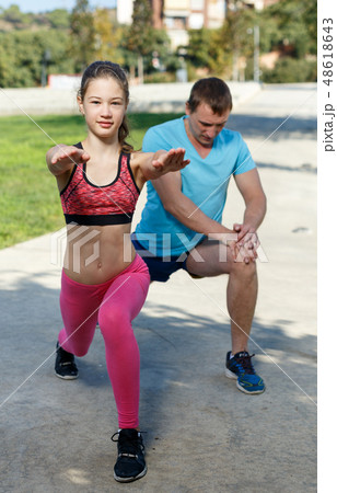 Girl stretching together with father Girl stretching together with father 48618643