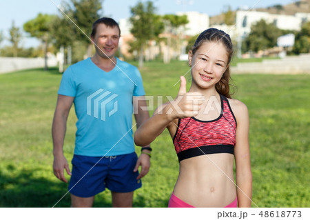 Smiling girl ready for training with father 48618773