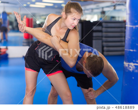 Glad female is fighting with trainer 48618889