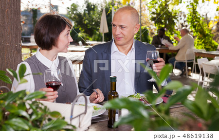 Couple in love drinking red wine at open-air restaurant 48619138