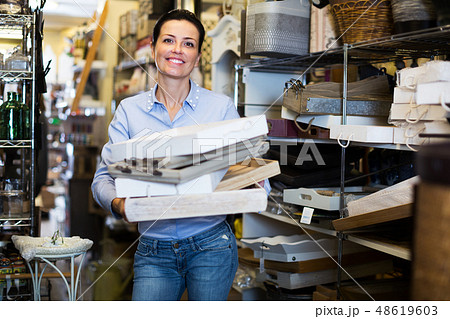 Woman standing with wooden box Woman standing with wooden box 48619603