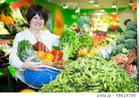 Mature woman buying fresh vegetables Mature woman buying fresh vegetables 48619700